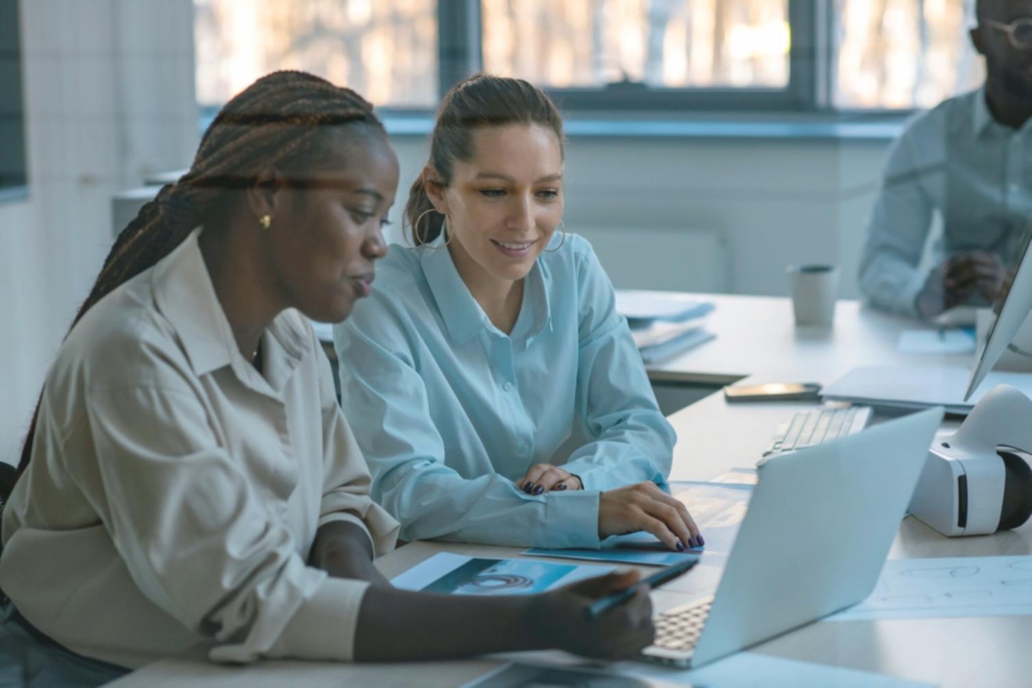 Students collaborating on financial analysis projects in modern learning environment